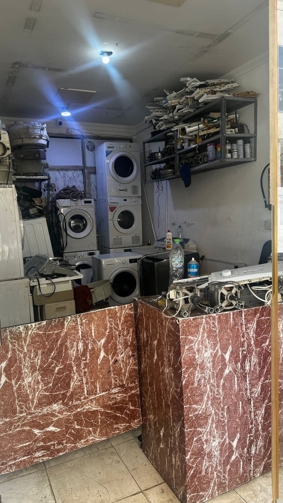 Workshop shelves stocked with motors, control boards and spare parts