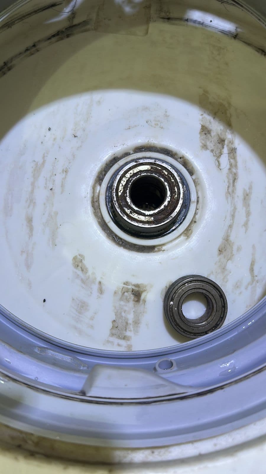 Worn washing machine bearings taken out of the drum during repair