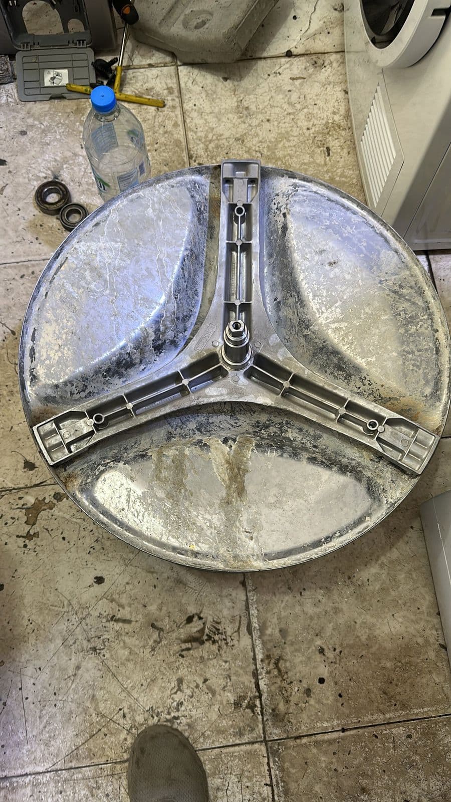Washing machine drum removed from the machine during a repair